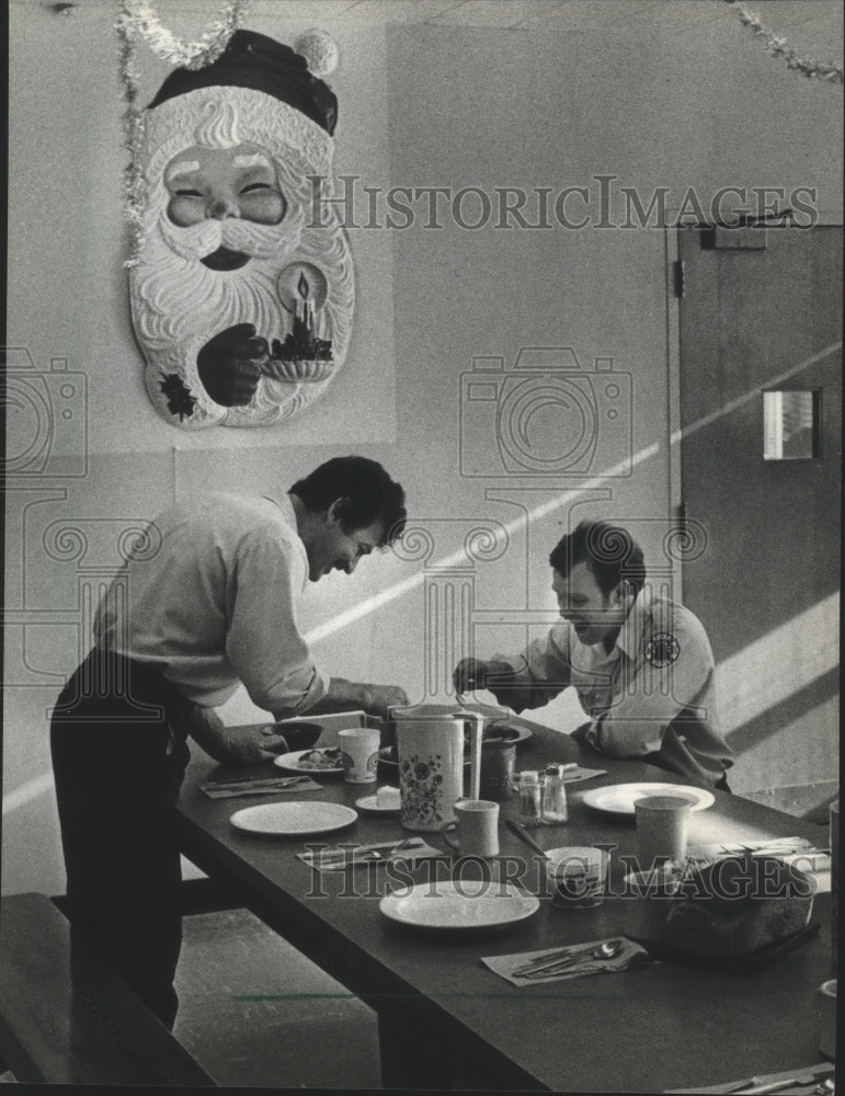 1982 Two fireman prepare to eat their Christmas meal, Milwaukee-Historic Images