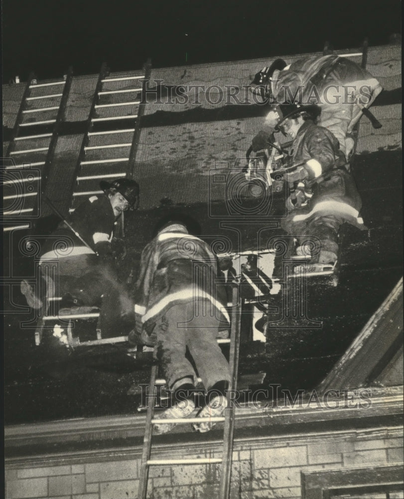 1979 Fire fighters working on the roof of an apartment, Milwaukee.-Historic Images