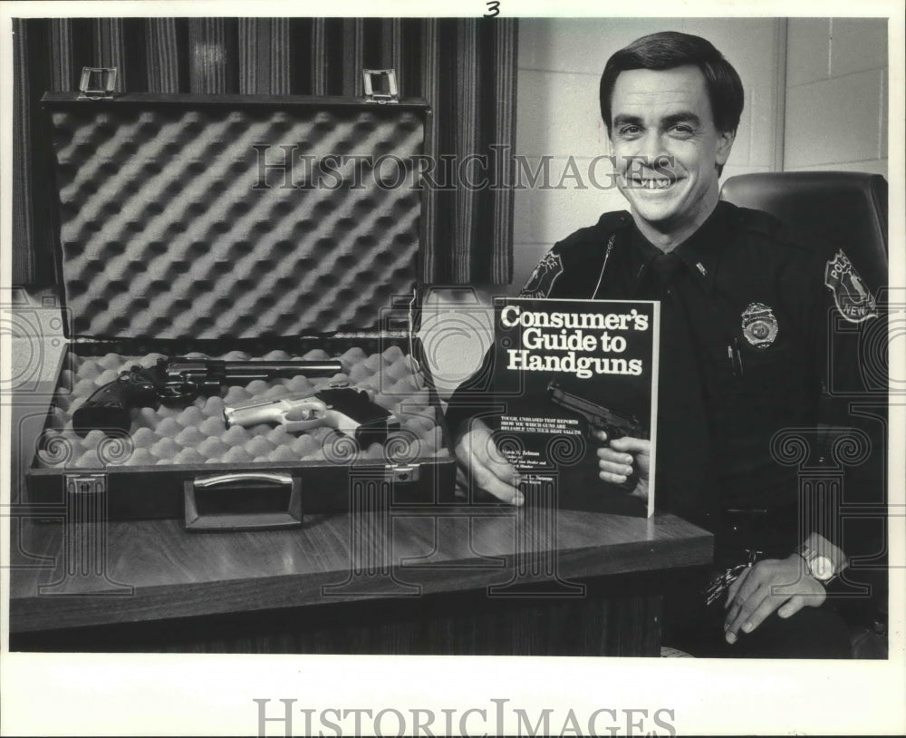 1986 Press Photo New Berlin Lt. Michael Neuens holds a guide to handguns - Historic Images