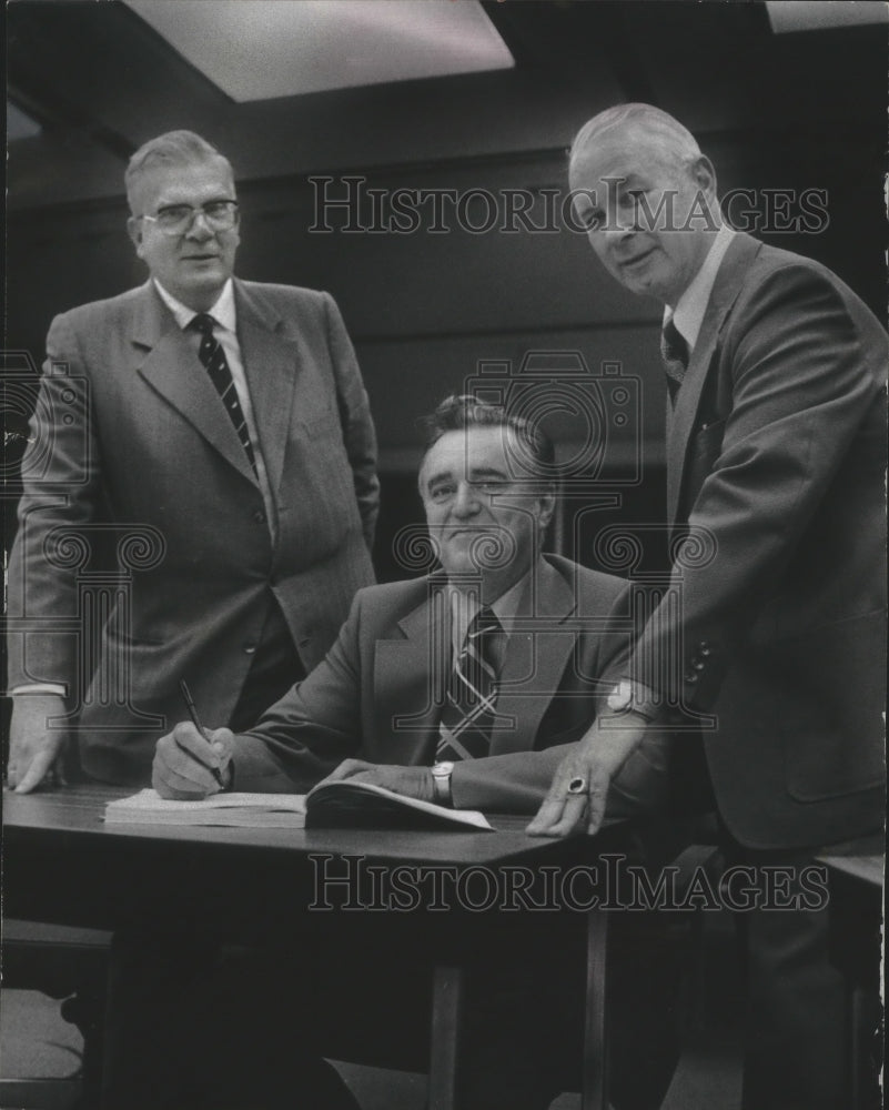 1977 Press Photo Carel Nengerman, business men sign agreement for Time Holdings. - Historic Images