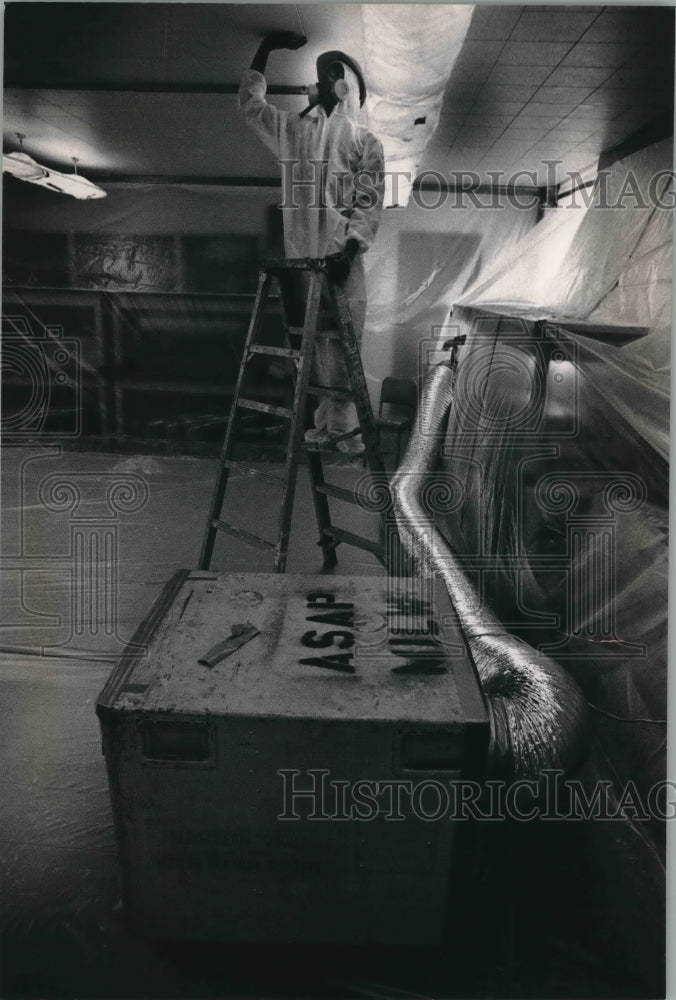 1989 Darrell Alexander checks for asbestos, Nicolet High School - Historic Images