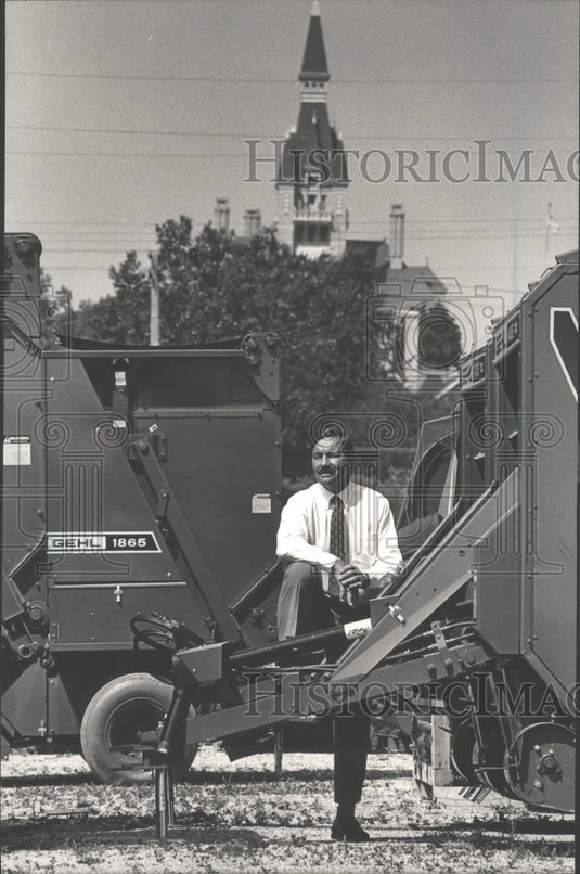 1988 Bernard Nielsen sitting on new Gehl balers West Bend Wisconsin-Historic Images