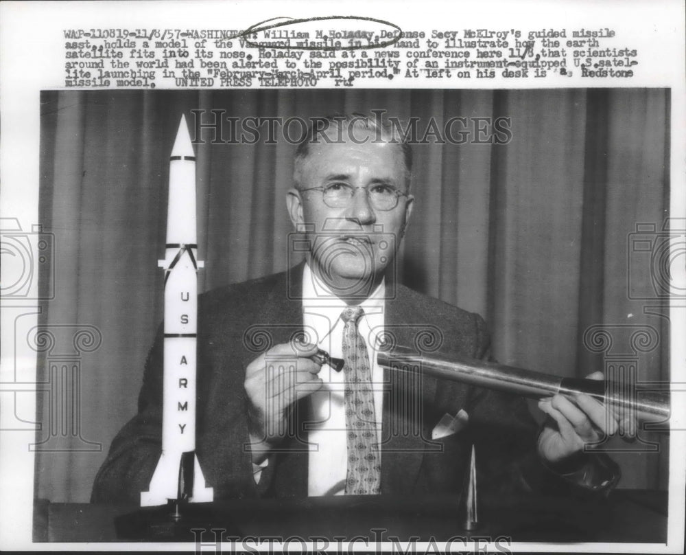 1957 Press Photo William Holaday, illustrates how the satellite fits, Washington - Historic Images