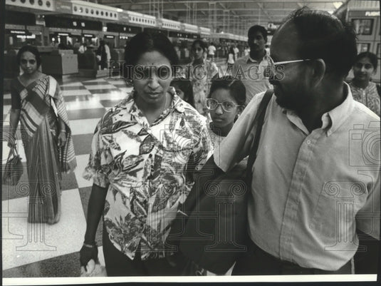 1990 Madhavarao Murikipudi carries wife's bags at O'Hare airport-Historic Images