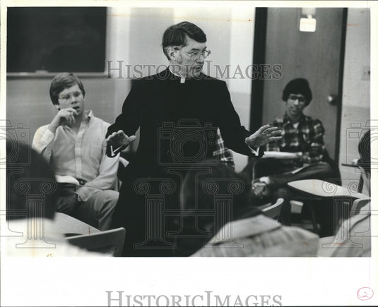 1981 Father William J. Kelly teaches Introductory Theology. - Historic Images