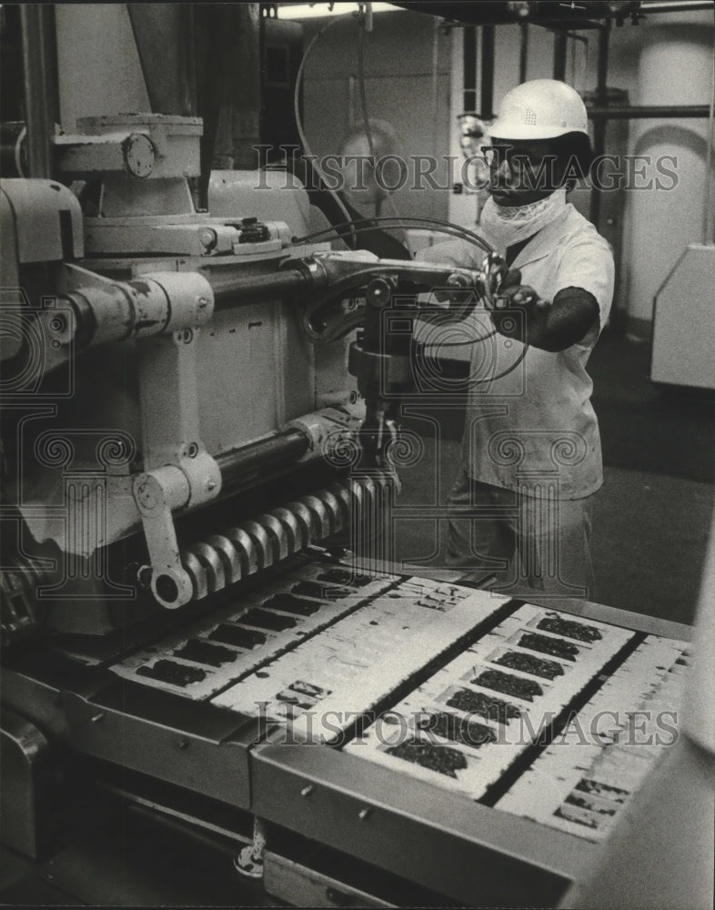 1981 Bobby Garry operates candy machine at The Johnston Company-Historic Images