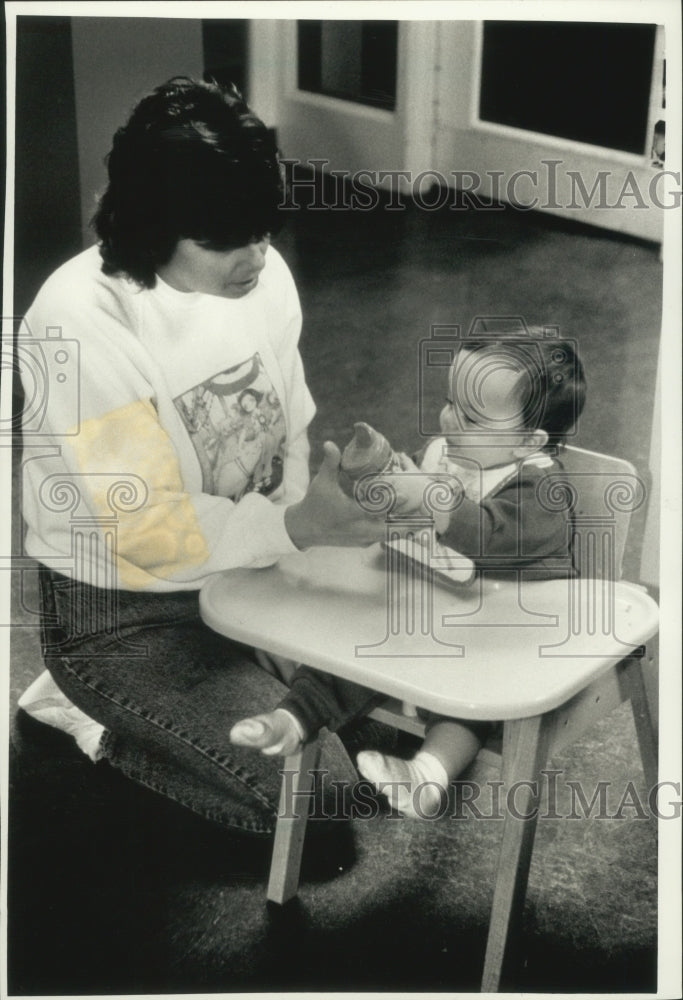 1992 Press Photo Child care worker and baby at Child-care center S. J. Johnson - Historic Images