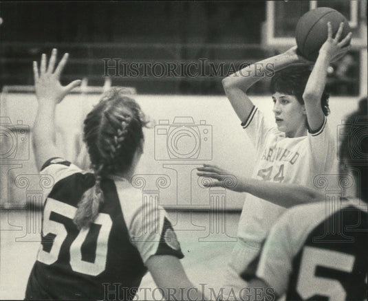 1986 Lynn Kamrath is blocked by Mukwonago opponent Shari Rudersdorf - Historic Images
