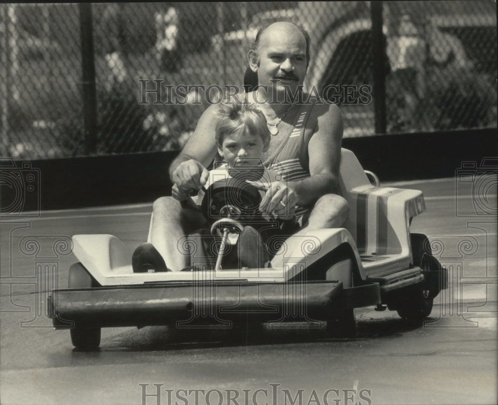 1983 Press Photo Man and boy riding a go kart. - mjb77189 - Historic Images