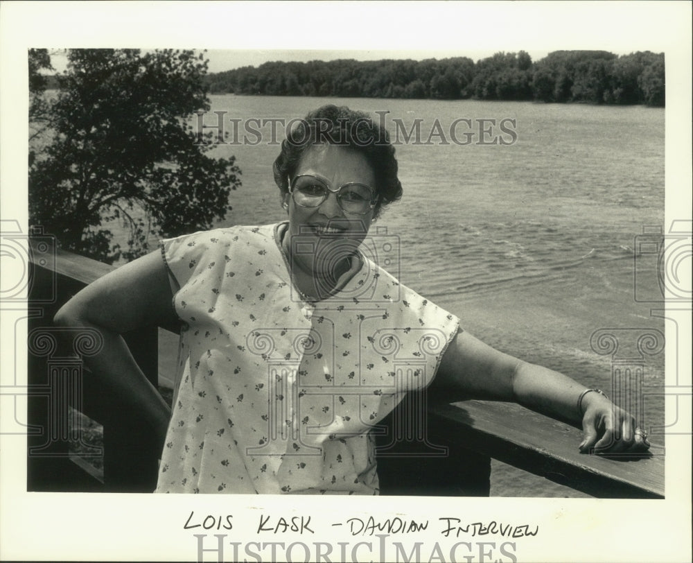 1986 Town treasurer Lois Kask stands next to Mississippi River-Historic Images