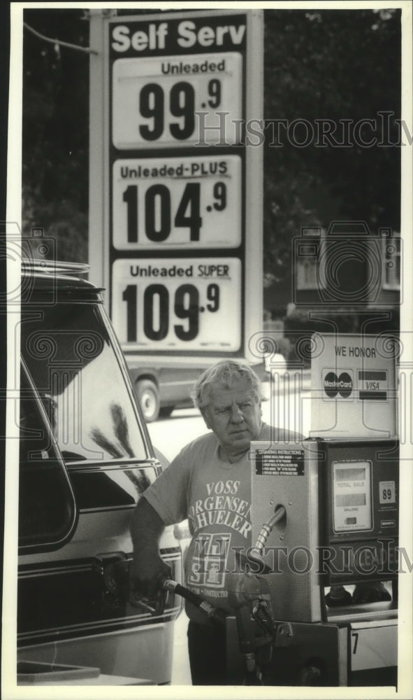 1993 Gasoline price war in Ozaukee County, Richard Jung fills van-Historic Images