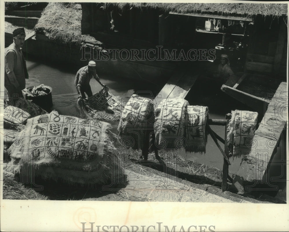 1979 Wokman cleans rugs in the Jheulum River in Pakistan-Historic Images
