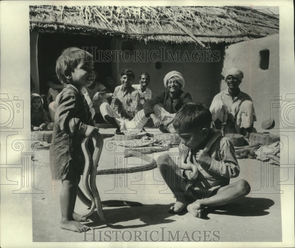 1976 Children learn how to handle snakes at Morbund, India-Historic Images