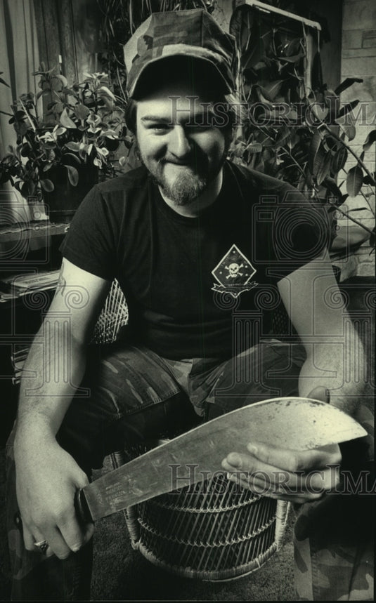 1986 Philip Rowlands plays with machete at parents home in Madison-Historic Images