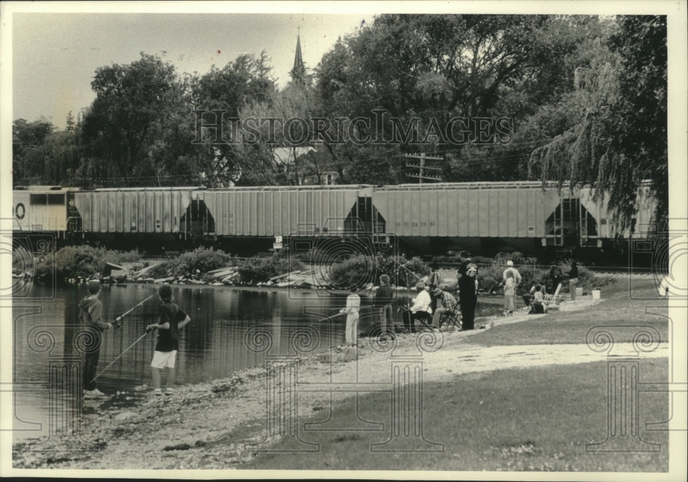 1990 Fishing enthusiasts at Pewaukee Lake in downtown Pewaukee-Historic Images