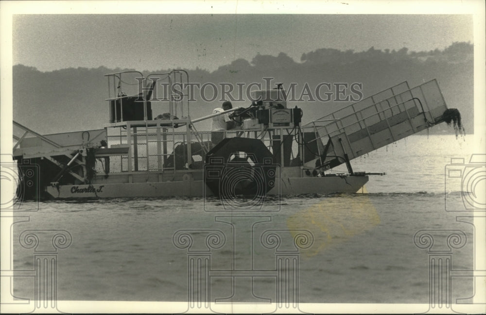 1989 A weed harvester from Sanitary District on, Pewaukee Lake. - Historic Images