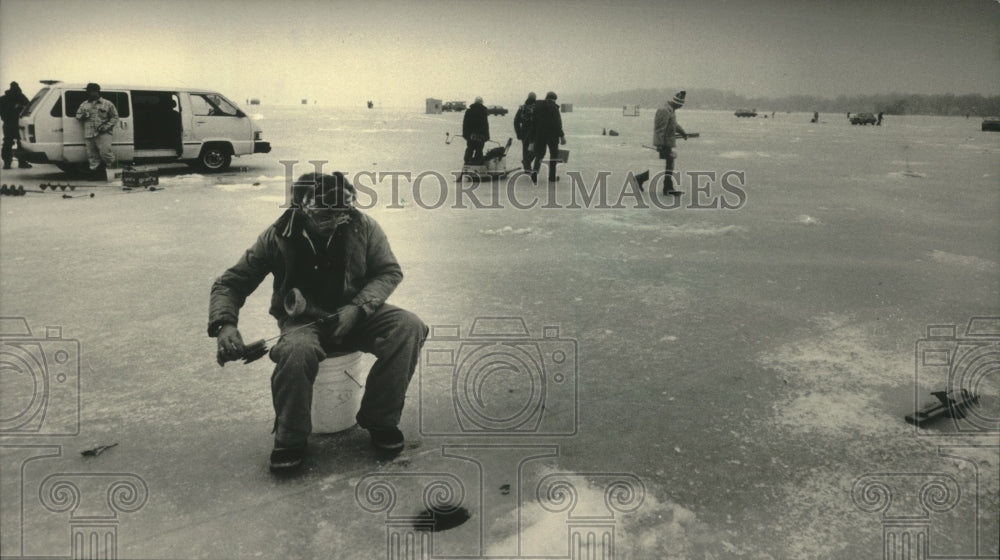 1986 Ice fisherman on ice of Pewaukee Lake - Historic Images