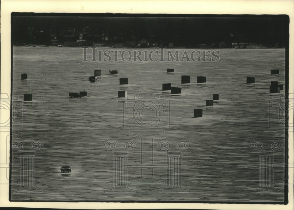 1988 A car moved across the ice on Pewaukee Lake-Historic Images