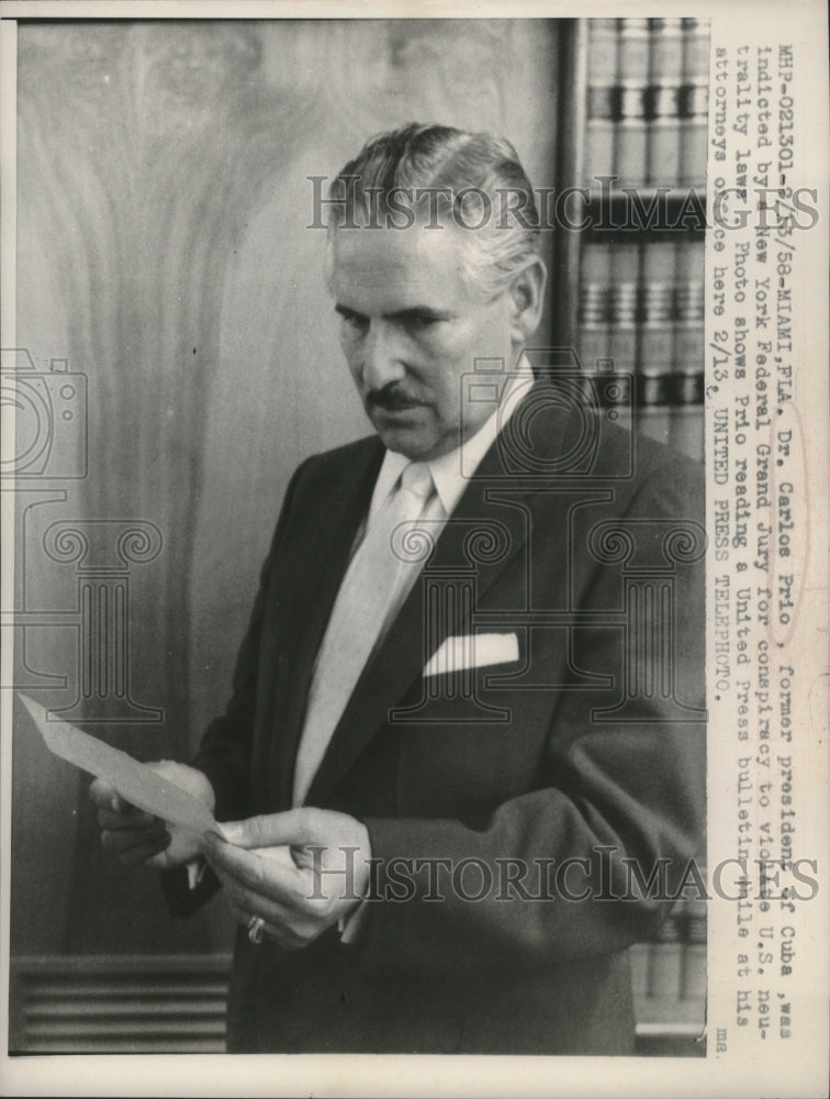 1958 Press Photo Dr. Carlos Prio reads United Press bulletin in lawyers office-Historic Images