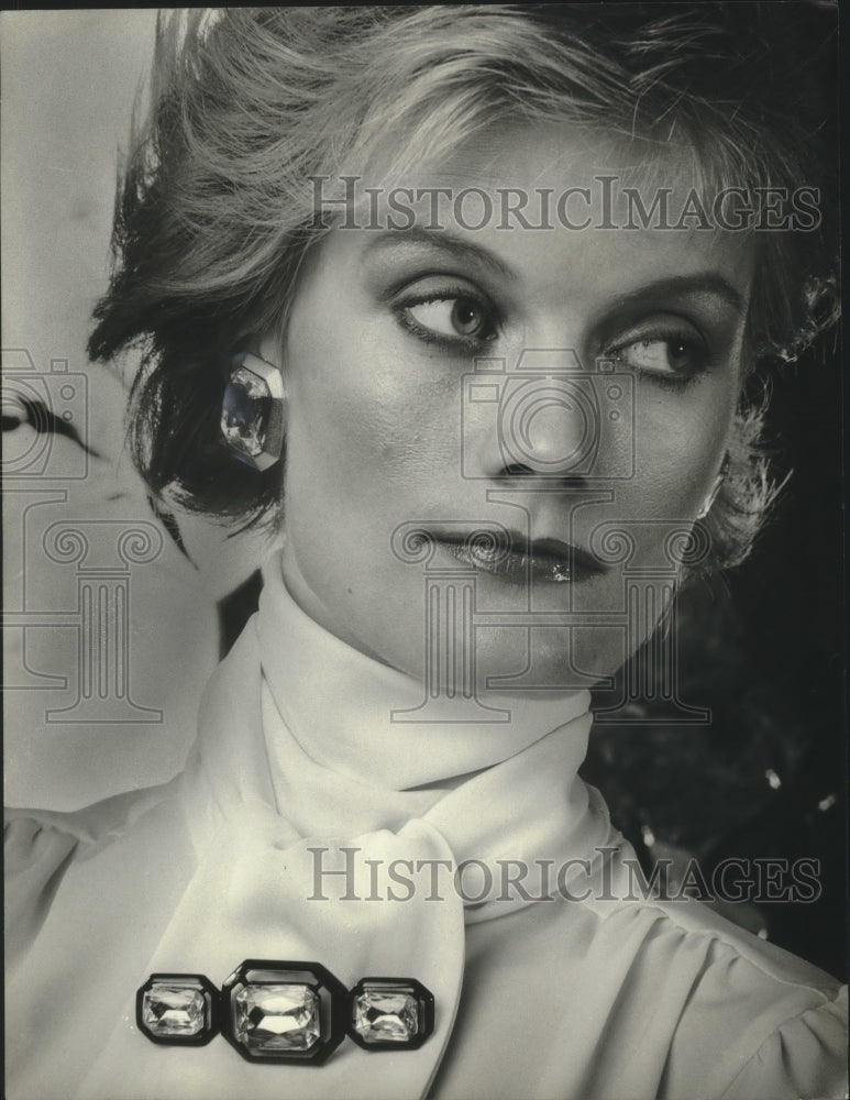 1983 Woman wearing Earrings and crystal bar pin from Craigs - Historic Images