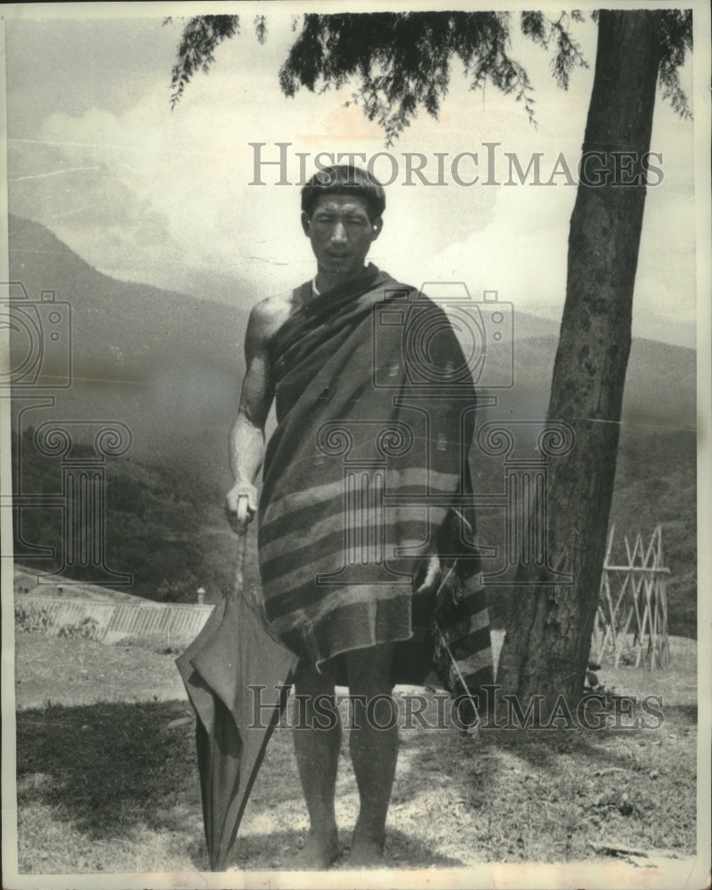 1956 Press Photo Naga visitor wears traditional shawl while carrying umbrella - Historic Images