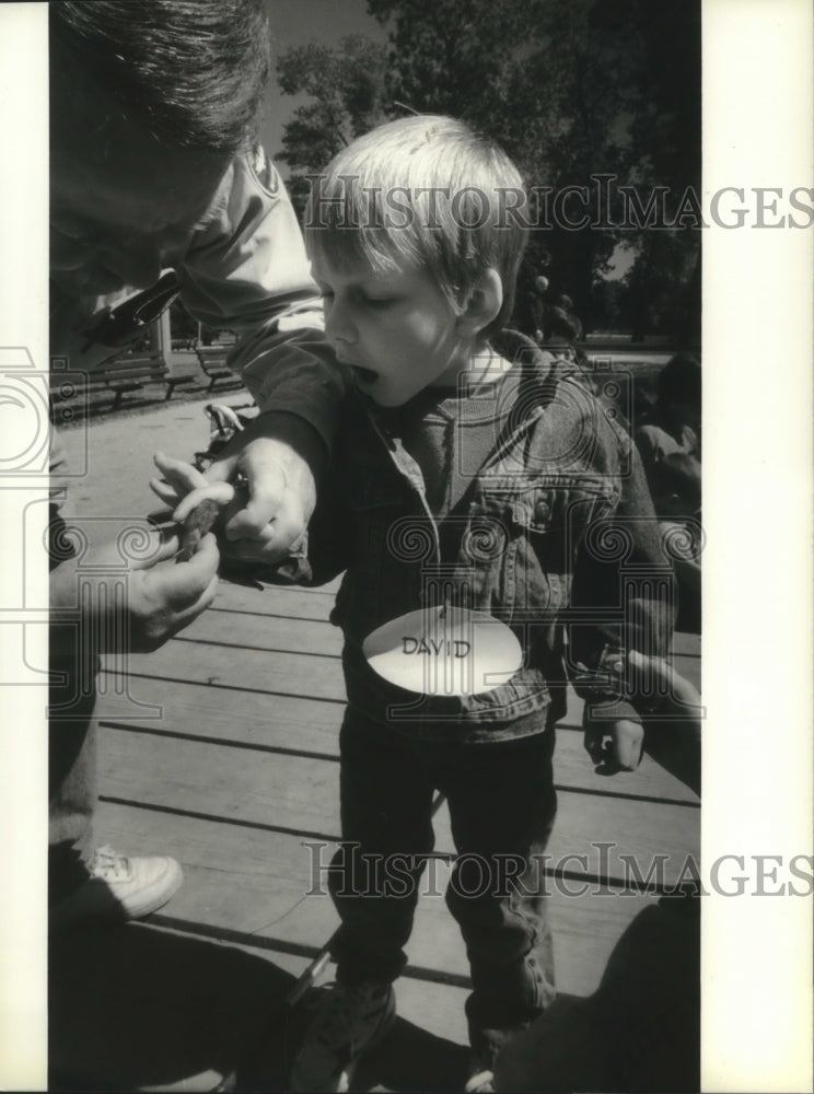 1994 David Stockland, 3, cautiously touches a bluegill, Wisconsin-Historic Images