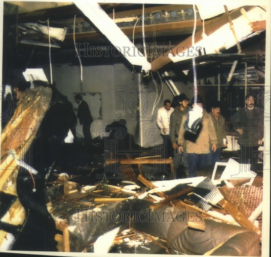 1993 Iraq rescue workers survey damage to Baghdad's Al Rashid Hotel - Historic Images