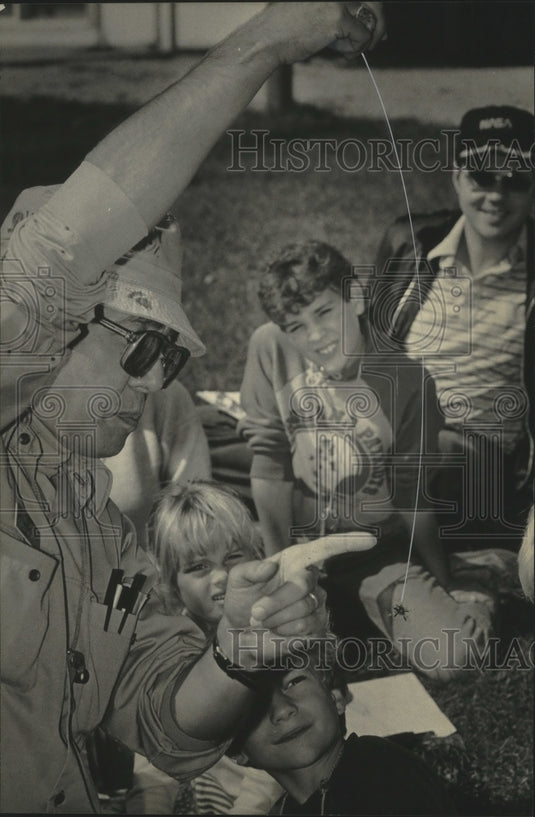 1984 Andy Larsen shows shamrock spider at Riveredge Nature Center - Historic Images