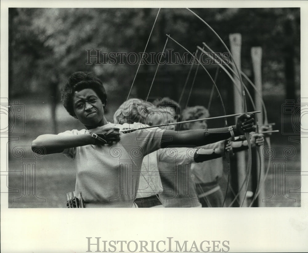 1983 Rose Kajumbula, shoots bow and arrow , Milwaukee-Downer College-Historic Images