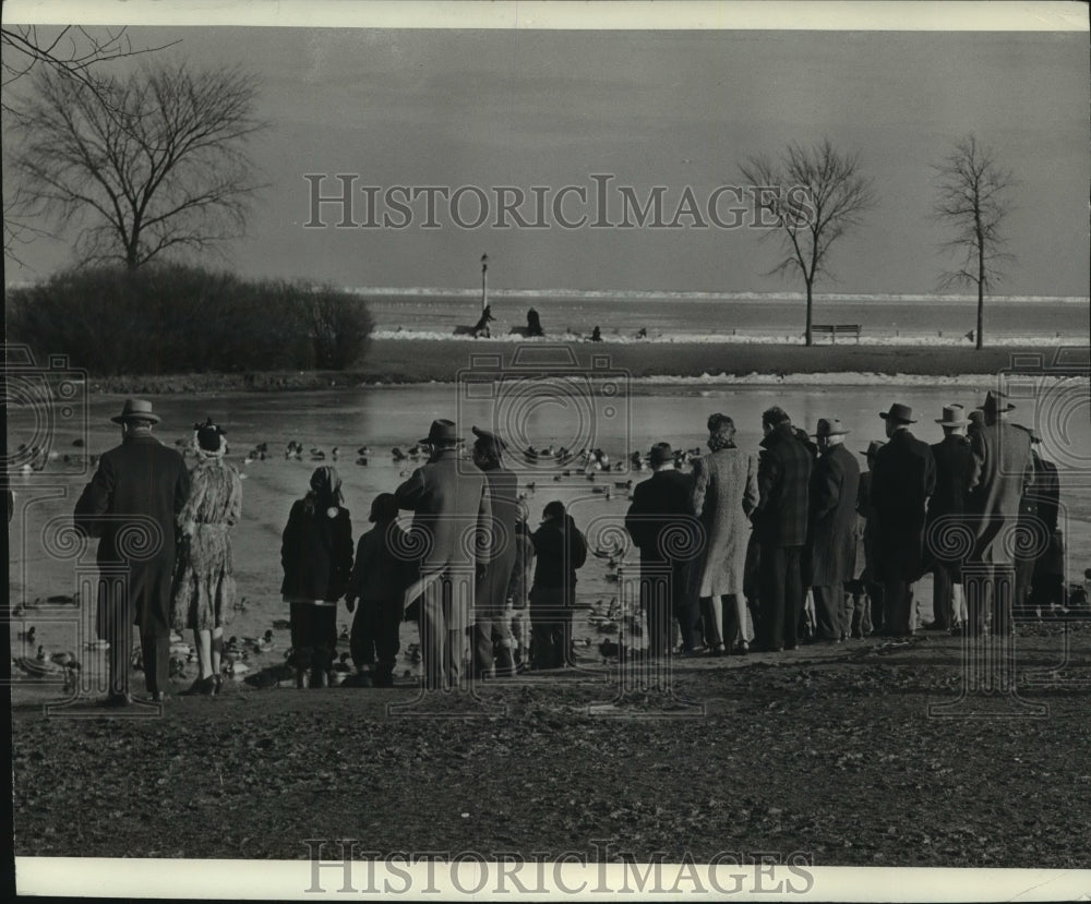 1946 People on bank, Juneau park lagoon, watching the ducks-Historic Images