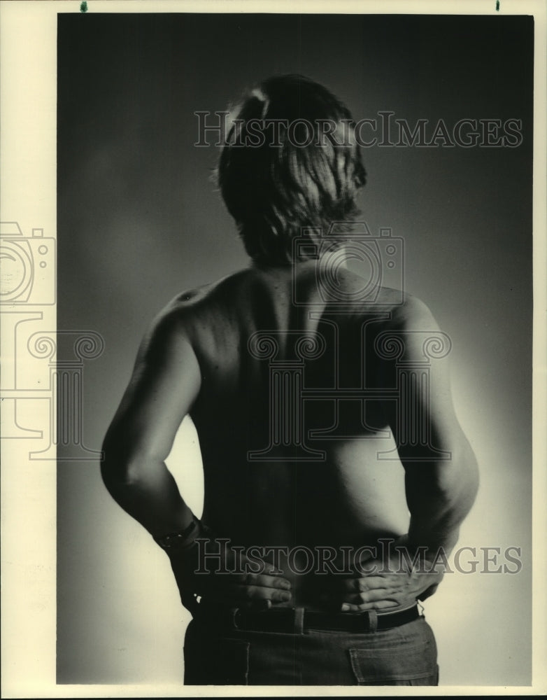 1984 Press Photo Man grasps lower back in pain - mjb84608 - Historic Images