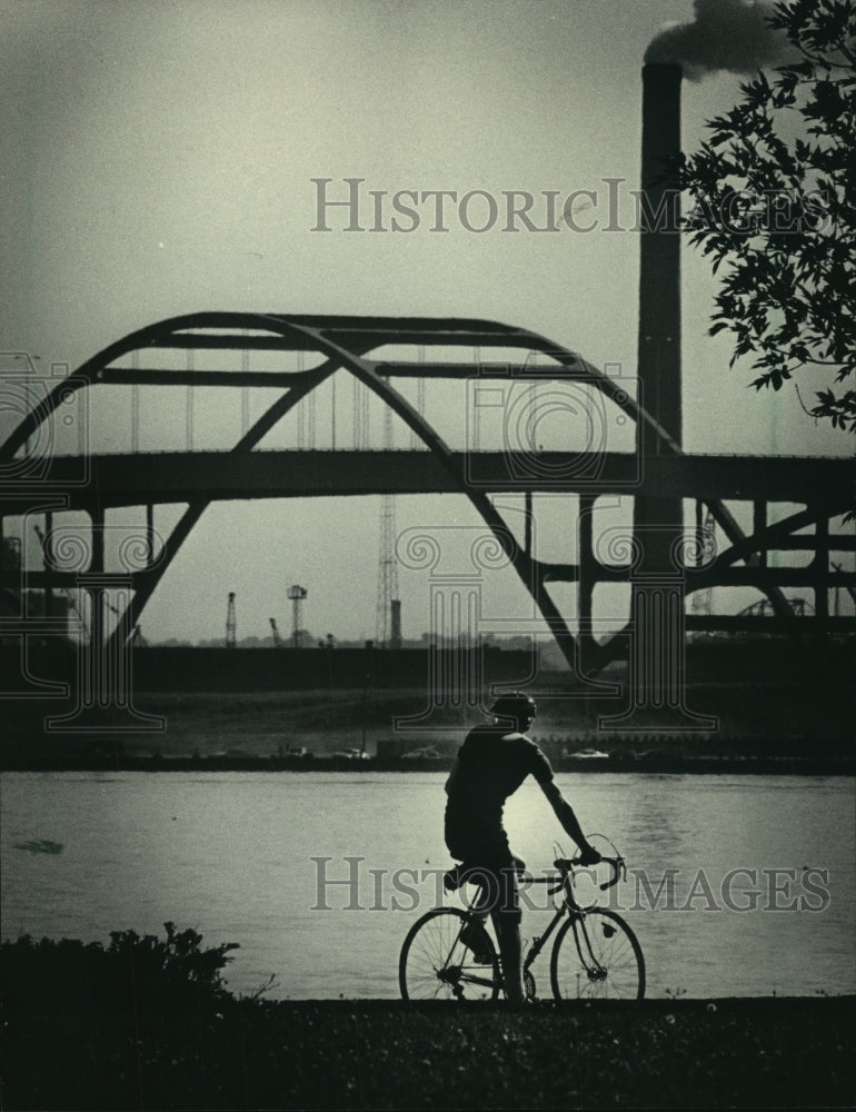 1984 Bicyclist rests as he rode in Juneau Park near McKinley Marina - Historic Images