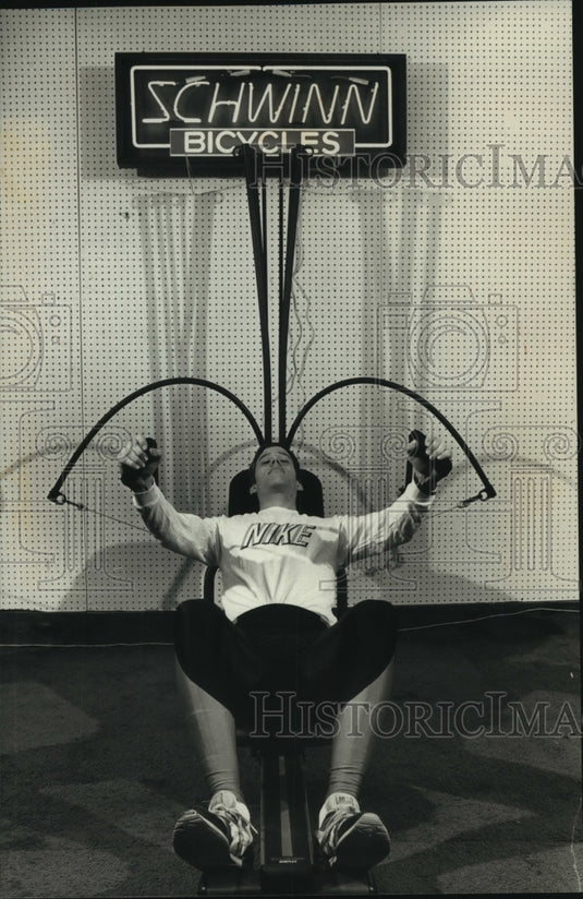 1989 Joel Buth of Grandview Cyclery & Fitness uses Bow Flex machine - Historic Images