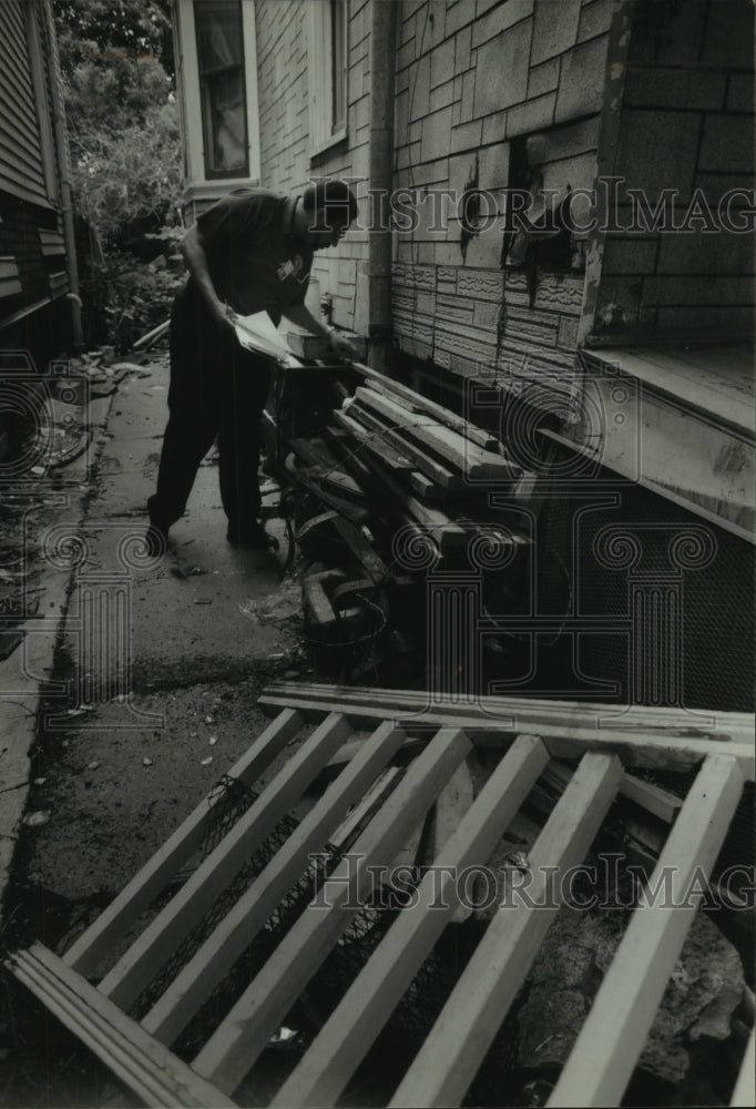 1994 Michael Pitts, Milwaukee city health inspector inspects rubbish-Historic Images
