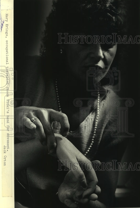 1986 Occupational therapist checks hand, Sacred Heart Rehab Hospital-Historic Images