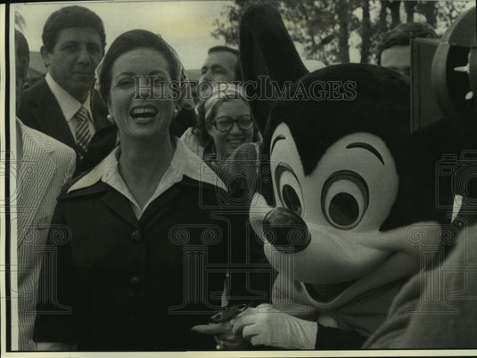 1975 Mrs. Anwar Sadat holds Mickey Mouse's hand, tours Disney World-Historic Images