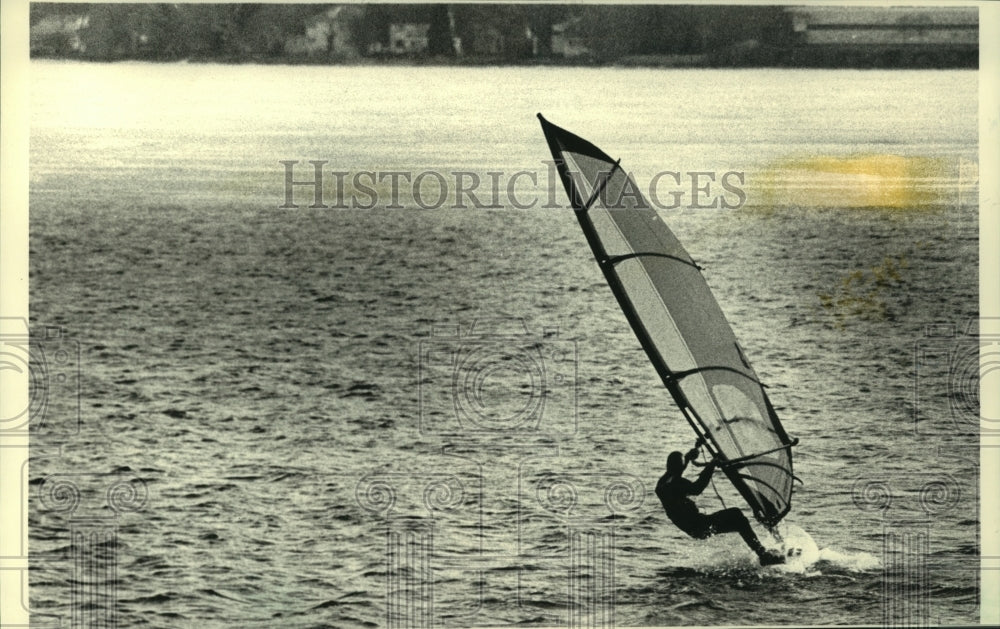 1988 William Tibble of Madison windsurfs on Lake Monona in a wetsuit - Historic Images