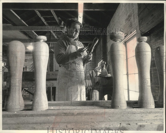 1961 Press Photo Shiptender Guaraldi comparing worn belaying pin and new pin. - Historic Images