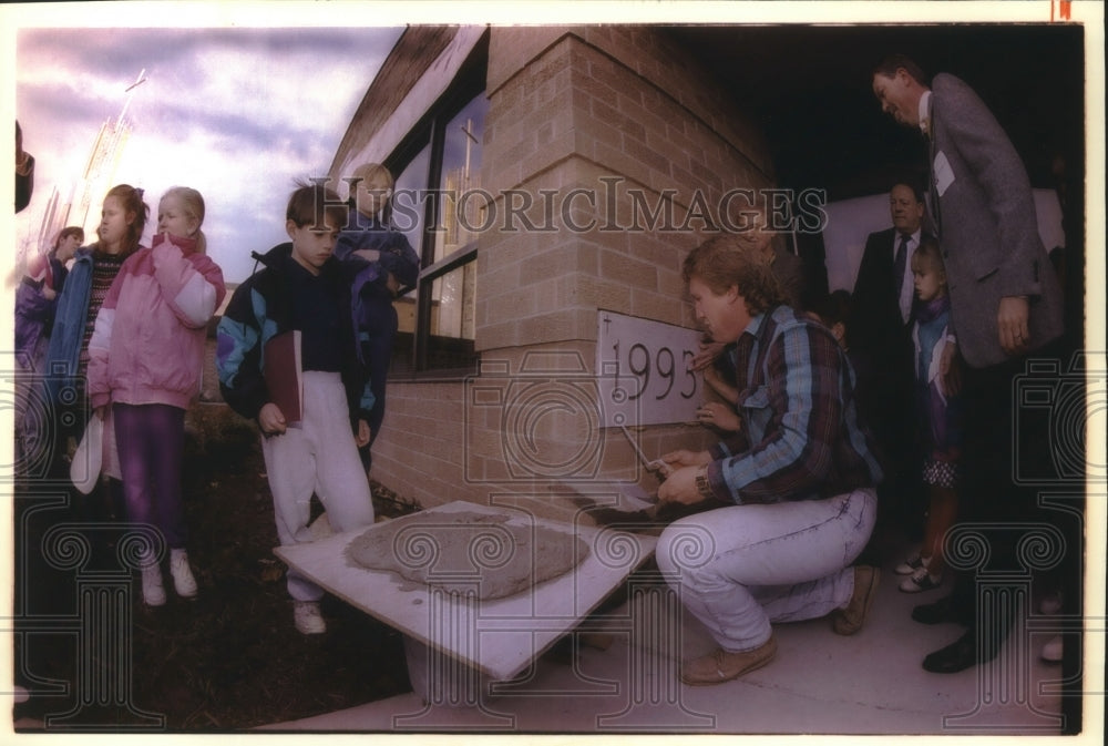 1993 Tony Fox sets cornerstone of St. John Vianney Catholic Church - Historic Images