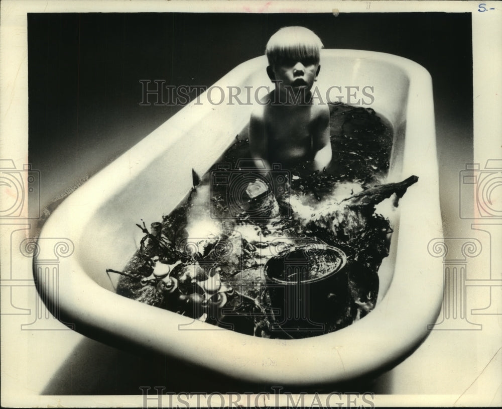 1968 Press Photo Boy in filthy water calls attention to Michigan pollution - Historic Images