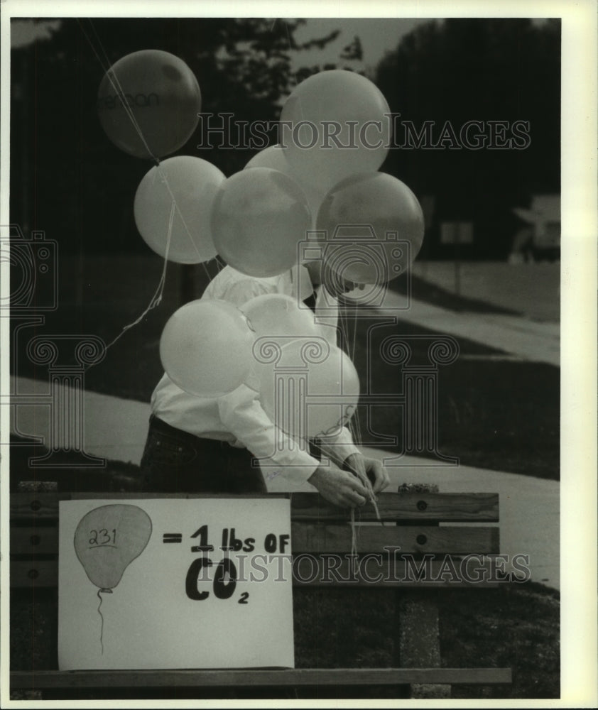 1994 Student, ties balloons around bench, Port Washington Schools - Historic Images