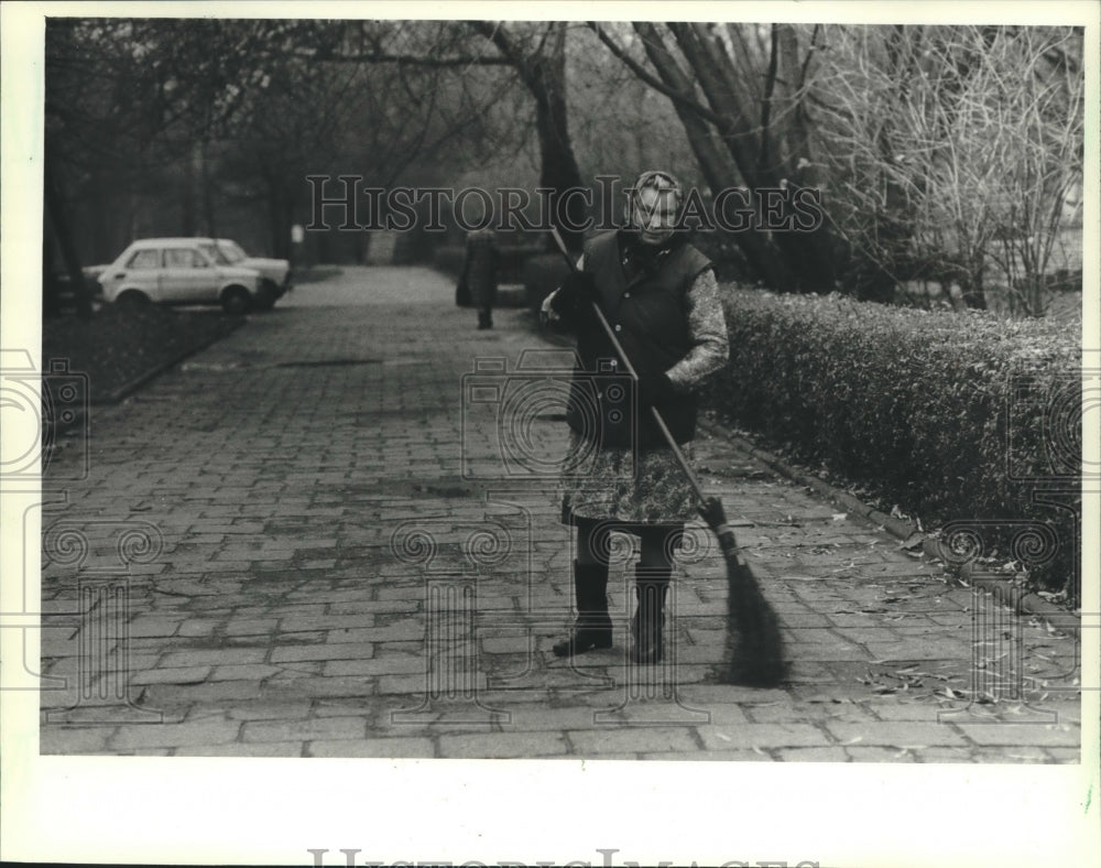 1981 Woman sweeping a city park walkway in Krakow, Poland-Historic Images