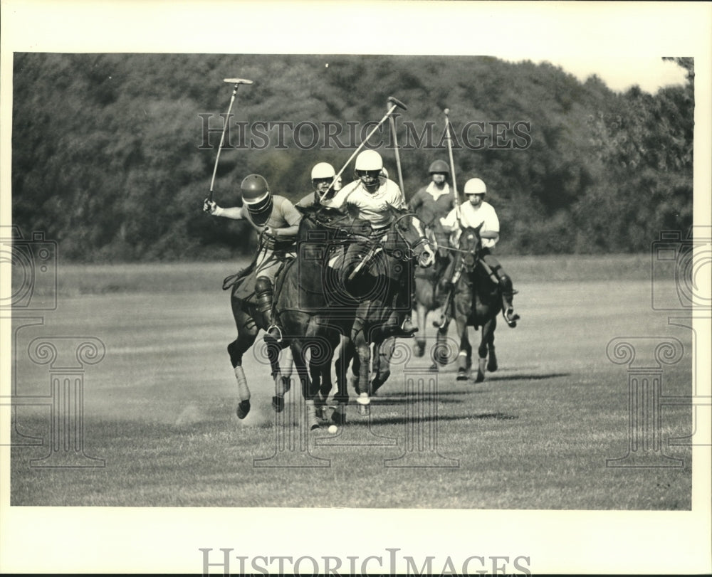 1987 Polo player, Tom Huber raised mallet to strike ball, Milwaukee - Historic Images
