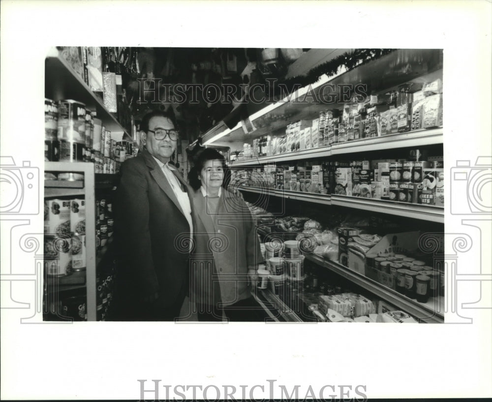 1994 Manuel and Quirina Oyervides stand in their store, Waukesah - Historic Images