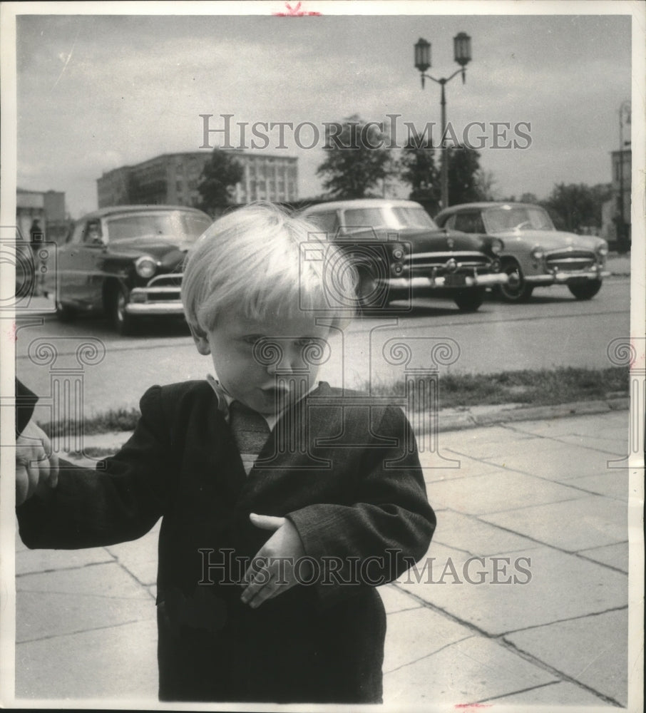Boy poses for photo in front of the American embassy Warsaw Poland-Historic Images