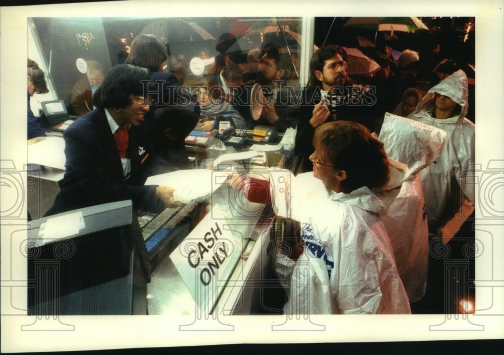 1993 Post office worker hands Elvis stamp to buyer in Milwaukee - Historic Images