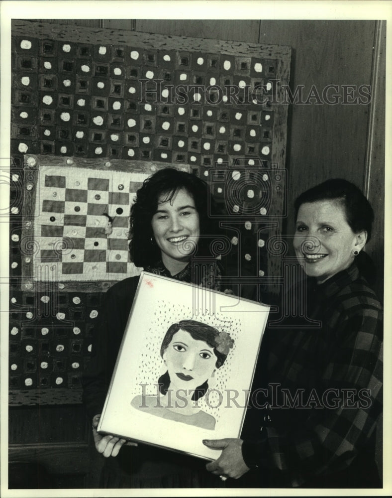1990 Katie Barthel, accepts a painting from Barbara Kohl Spiro-Historic Images