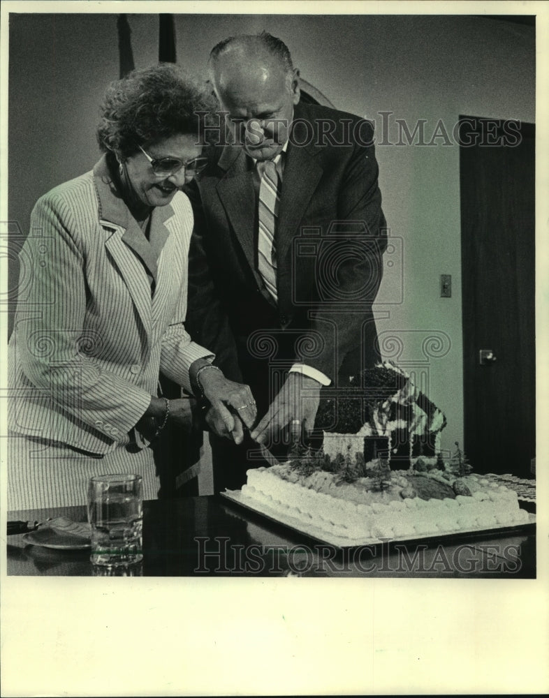 1986 Fire Chief, William Stamm and wife Etelka, cut retirement cake - Historic Images