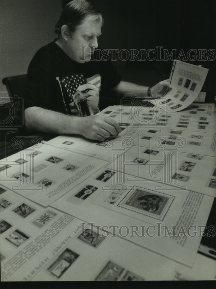 1993 Press Photo Roy Marks II, table covered, prize winning stamp collection - Historic Images