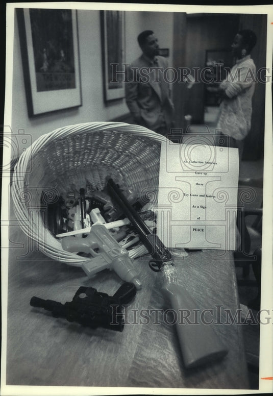 1993 Press Photo Children at St. Catherine's Catholic School turn over toy guns. - Historic Images